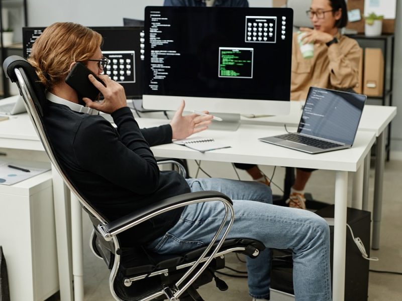 young-caucasian-male-programmer-calling-by-mobile-2022-02-10-05-19-28-utc-min